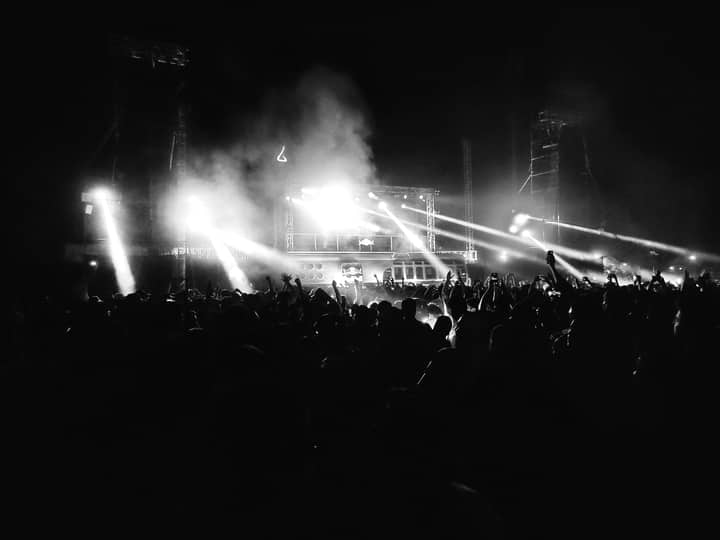 Energetic night concert with crowd, dazzling lights, and music in Kanpur, India.