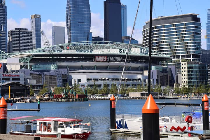 Marvel Stadium and city skyline in Melbourne, Australia by the waterfront.