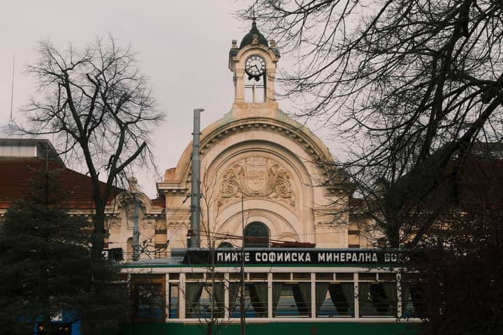 Beautiful architectural view of Sofia Central Mineral Baths with bare trees and a winter atmosphere.