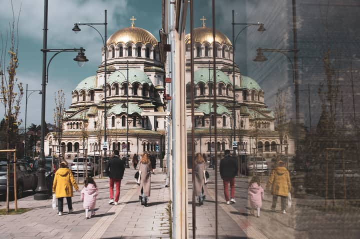 Street scene with reflection of Alexander Nevsky Cathedral, Sofia, Bulgaria.