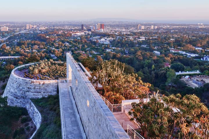 Stunning panoramic view from Getty Center featuring modern architecture and lush gardens against Los Angeles skyline.