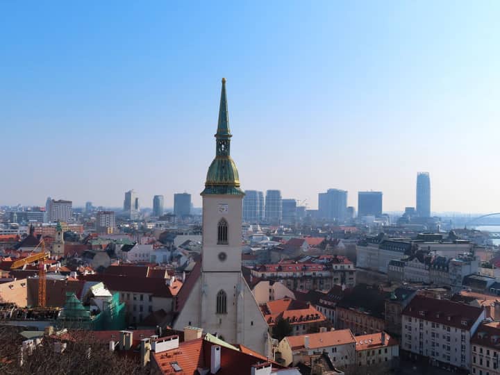 View of Bratislava skyline featuring St. Martin's Cathedral against modern architecture.