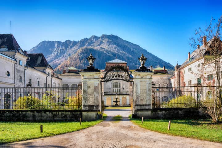 Scenic view of a historic castle in Lunz am See, Austria, with mountain backdrop.