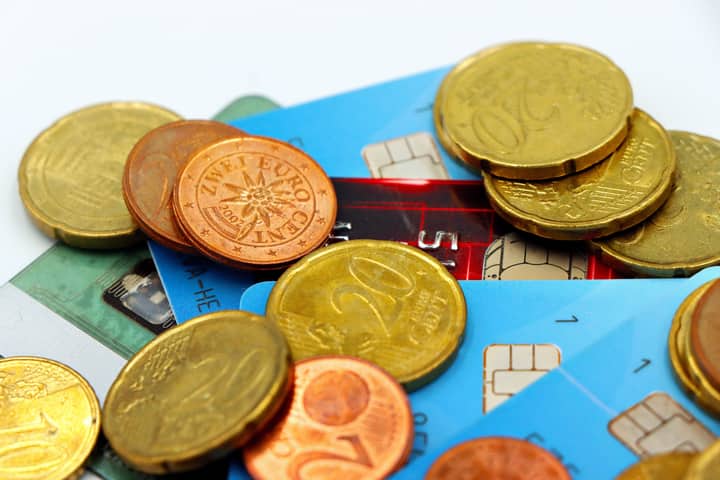 Close-up image of Euro coins and credit cards representing modern financial transactions.