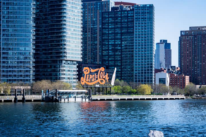 View of the iconic Pepsi Cola sign with high-rise buildings in Long Island City, New York.