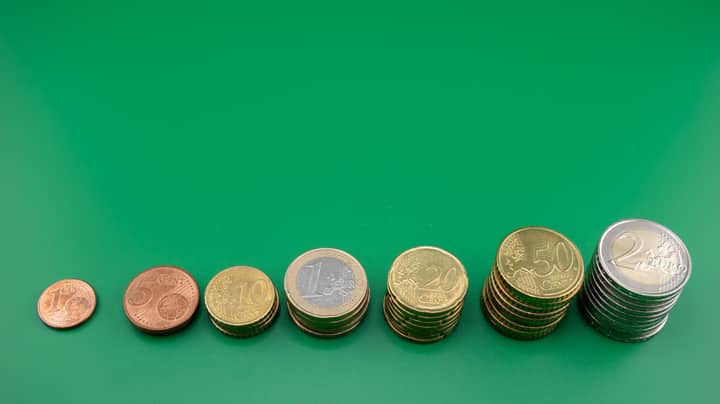 Various euro coins stacked incrementally on a vibrant green background.