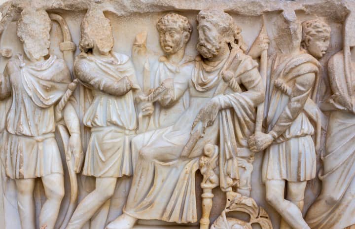 Ancient Roman marble relief showcasing historical figures in classical attire.