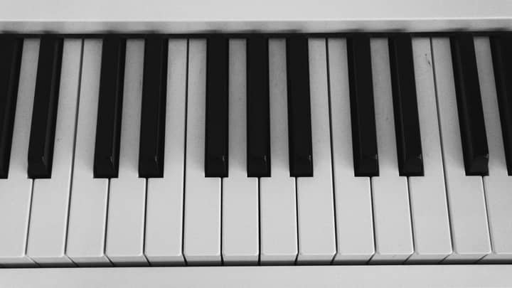 Monochrome close-up image of piano keys highlighting black and white contrast.