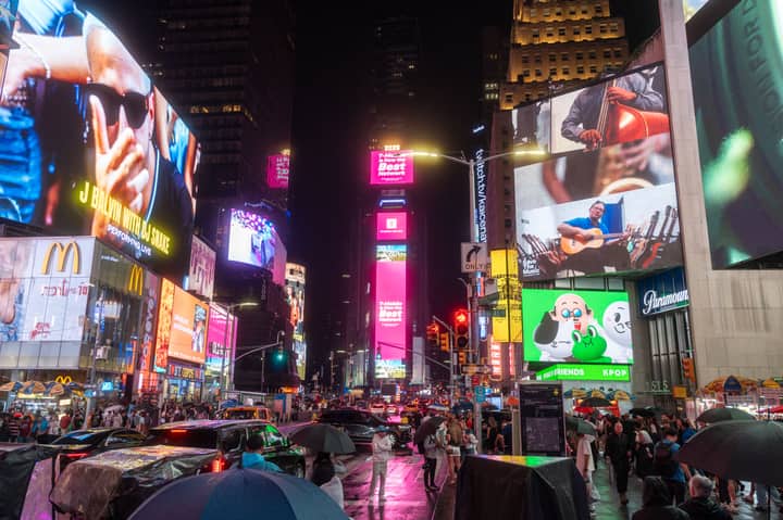 Experience the vibrant nightlife of Times Square, New York City, with brilliant lights and bustling crowds.