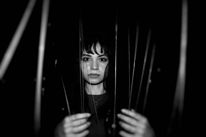 Dramatic black and white portrait of a woman in Istanbul, expressing emotion through art.