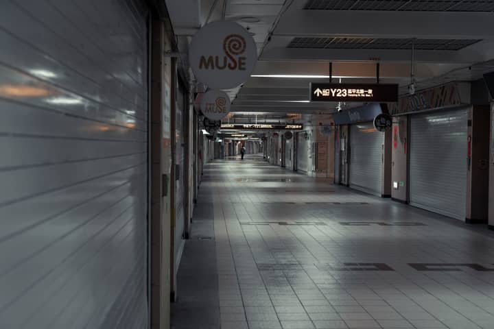 A deserted underground corridor in Taipei City showcasing urban architecture and signage.