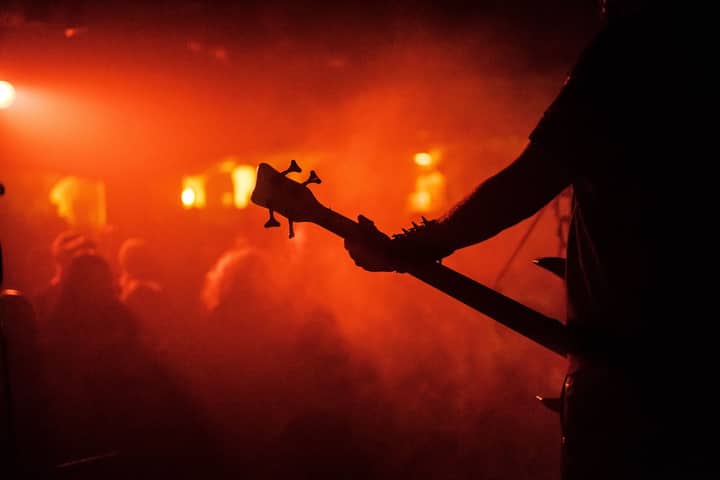 Dynamic live music scene with guitarist silhouette in Bristol, England.