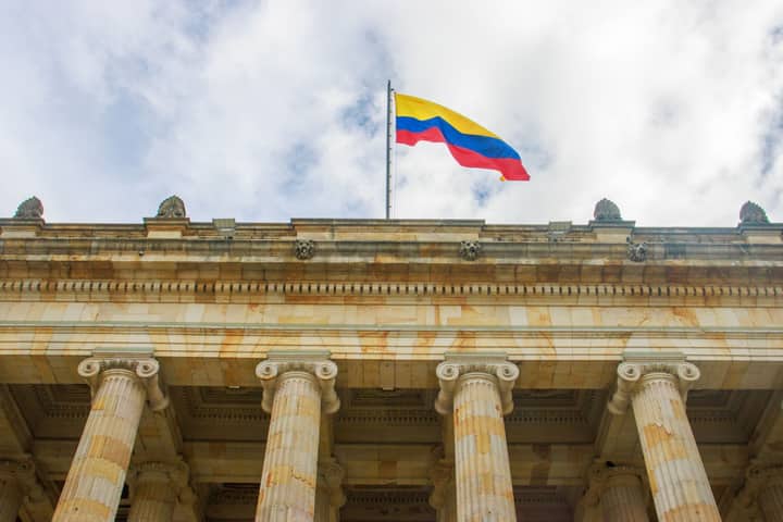 View of the Colombian Capitol Building in Bogotá with the Colombian flag displayed prominently.