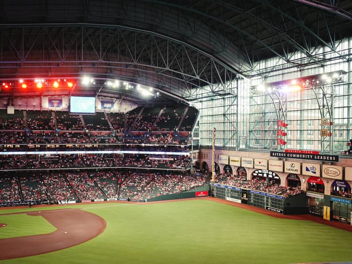 Exciting baseball game atmosphere at Minute Maid Park, Houston, with a large crowd enjoying the match.