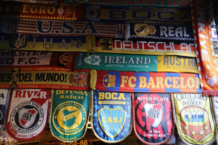 A vibrant array of international soccer fan scarves showcasing various teams.