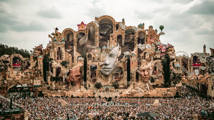 A breathtaking view of the Tomorrowland festival stage in Boom, Belgium, filled with vibrant decorations and a massive crowd.