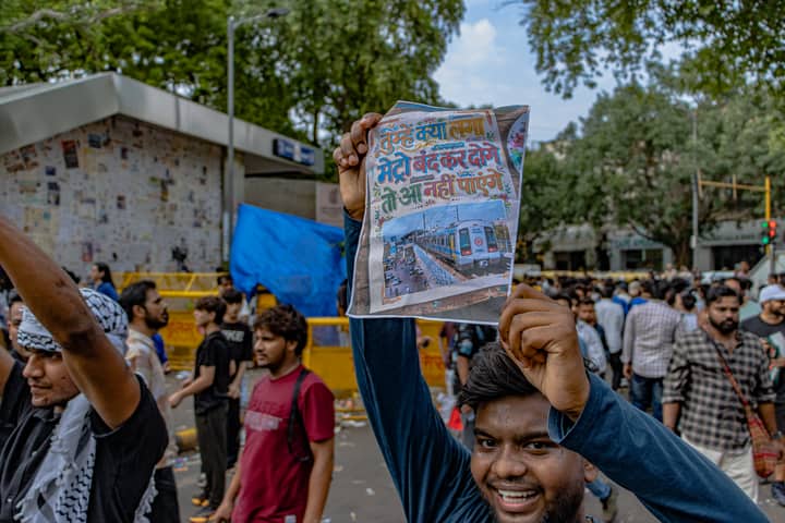 Protesters congregate at Jantar Mantar, New Delhi, holding up signs for peaceful demonstration.