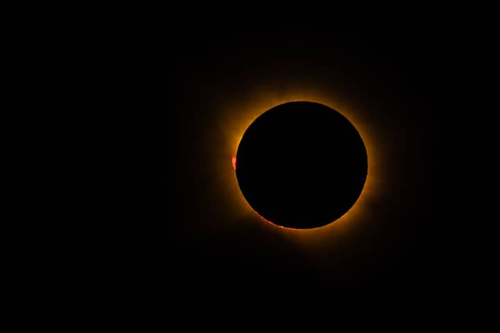 Capture of a total solar eclipse, showcasing the solar corona and lunar silhouette.