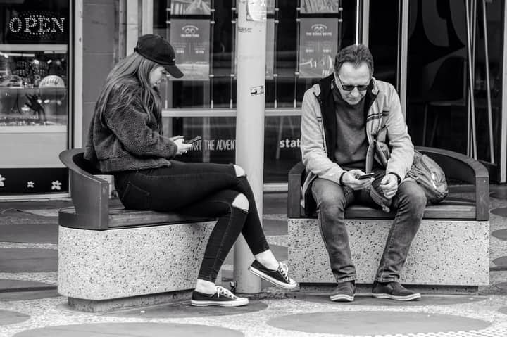 Candid street photography of people using smartphones in Melbourne, Australia.