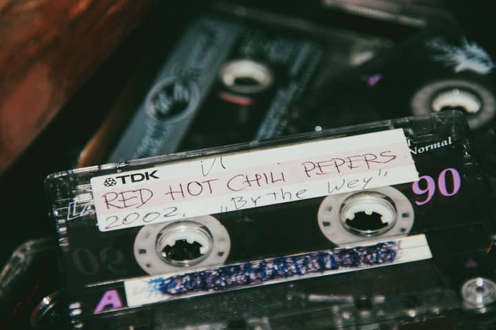 From above of vintage audio cassette with handwritten inscription placed on tape recorder