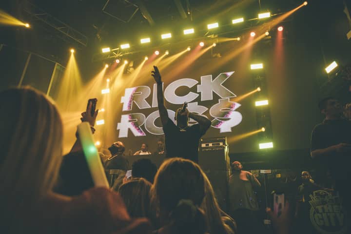 Engaging live concert with vibrant neon lights and enthusiastic crowd.