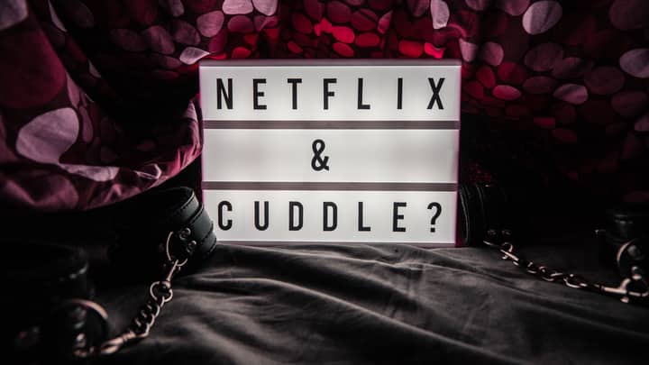 Lightbox with 'Netflix & Cuddle?' message surrounded by cozy setting and decor.