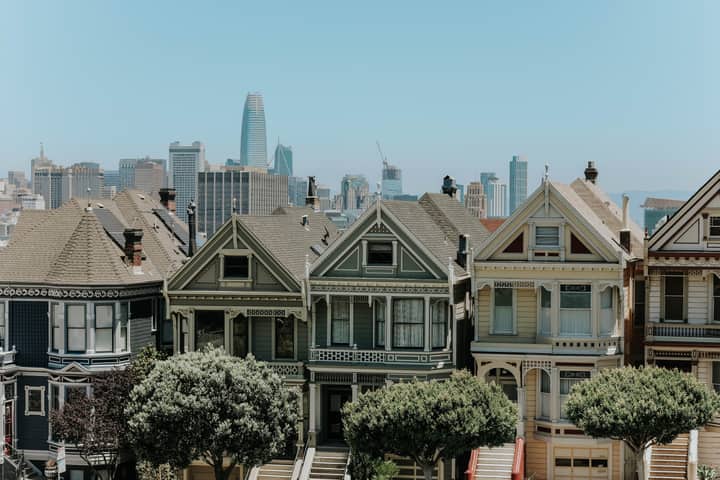Captivating view of San Francisco's famous Victorian houses with city skyline in the background.