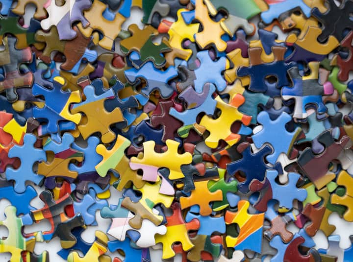 A vibrant close-up of multiple colorful puzzle pieces scattered randomly.