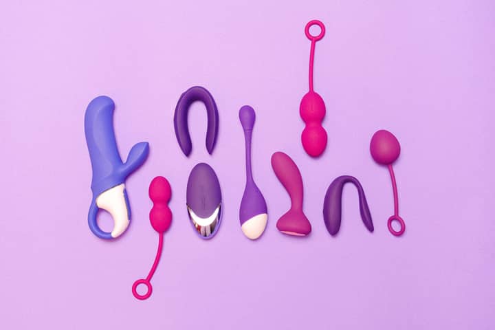 Various silicone sex toys displayed on a purple background for pleasure and education.