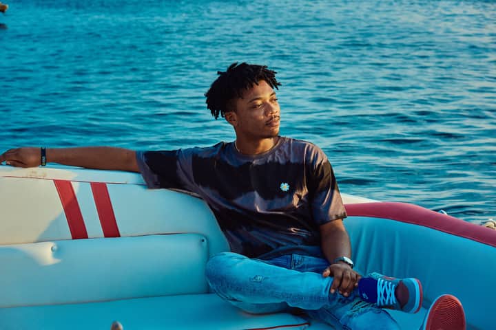 A young man enjoying a serene moment on a boat in Lagos, Nigeria.