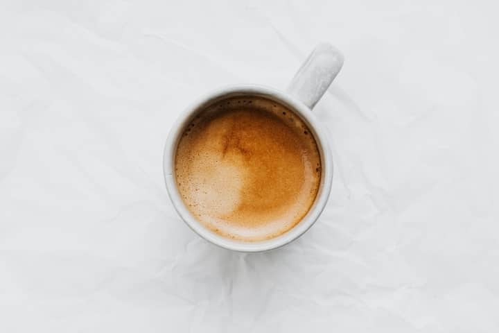 Aerial view of a coffee cup on a white background. Ideal for food and beverage themes.