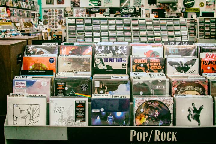 Explore a diverse collection of vinyl records in a vibrant San Mateo music store.