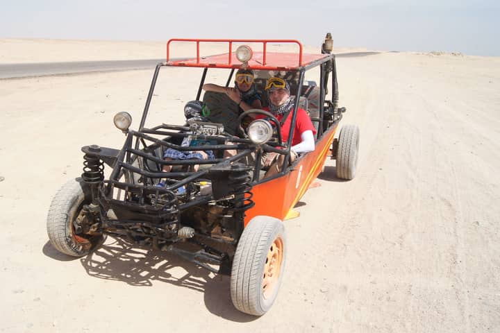Experience thrilling desert rides in open buggies under the bright sun.