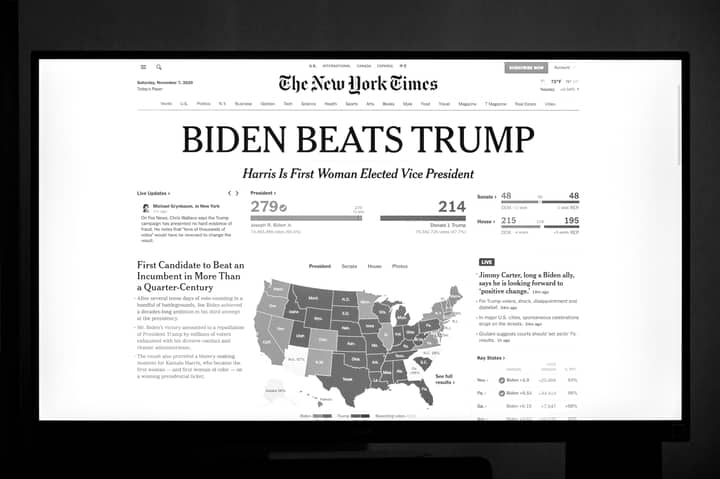 Biden wins presidency over Trump as detailed on newspaper front page.