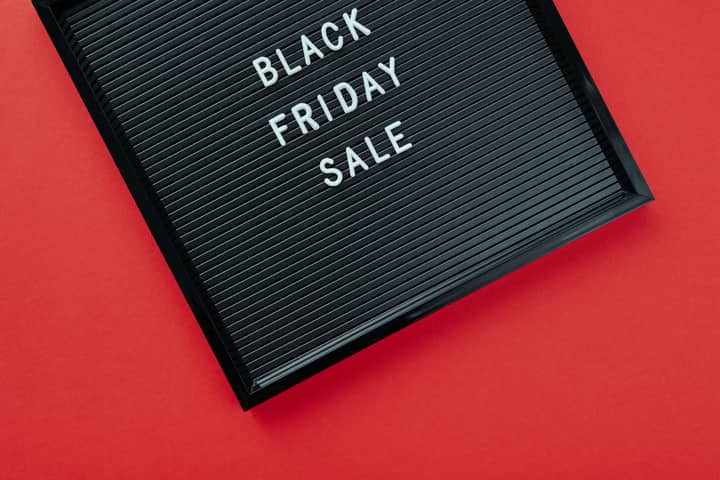 Black Friday sale sign on bold red surface, perfect for promotions.