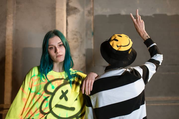 Trendy urban fashion with vibrant graffiti background featuring unique street style.