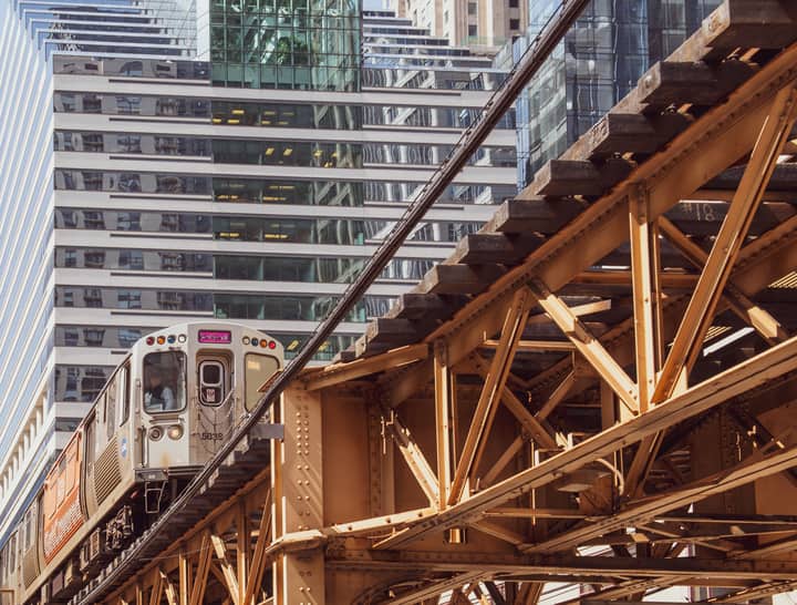 Chicago's elevated train passing through downtown with modern skyscrapers in the background.
