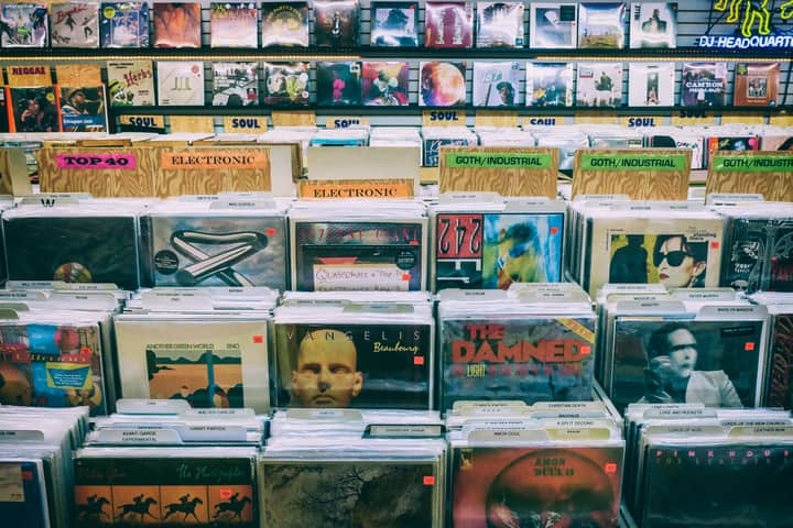 A vintage vinyl record display with diverse music genres in a classic music store.