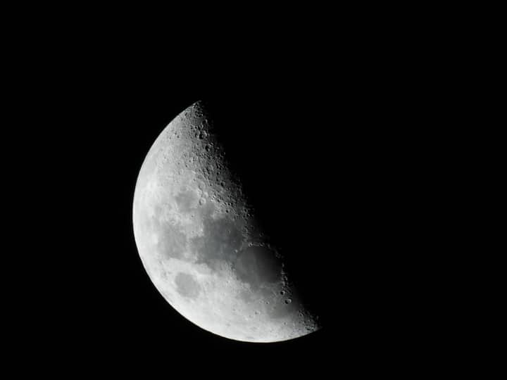 Close-up of the moon in black and white, showcasing its craters and texture.