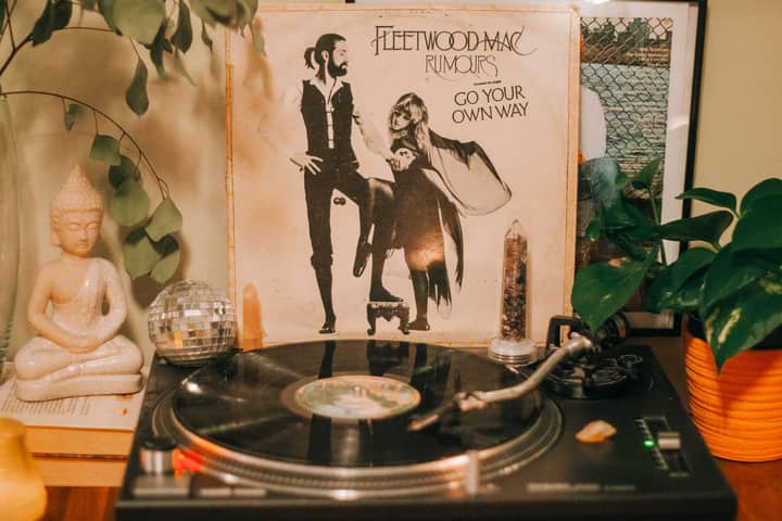 Cozy indoor scene featuring a vintage turntable and Fleetwood Mac Rumours album with decorative elements.