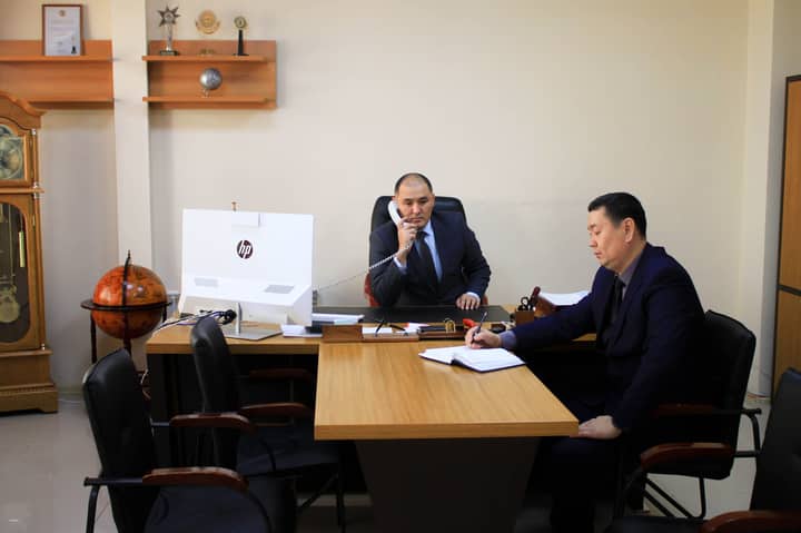 Two businessmen engaged in a planning meeting in a corporate office setting.