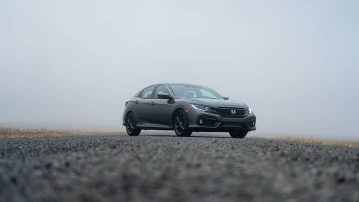 A sleek Honda Civic parked on a foggy day in Fort Wayne, Indiana.