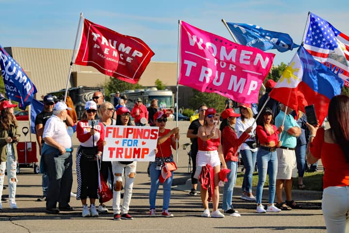 A group of diverse supporters at a political rally in Michigan.