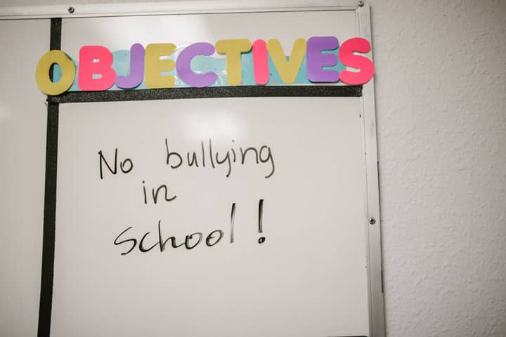 Whiteboard with 'No bullying in school!' message promoting anti-bullying awareness.