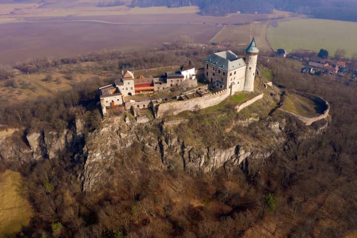 Aerial view of medieval Kuneticka Hora Castle, a tourist landmark in the Czech Republic, at sunrise.