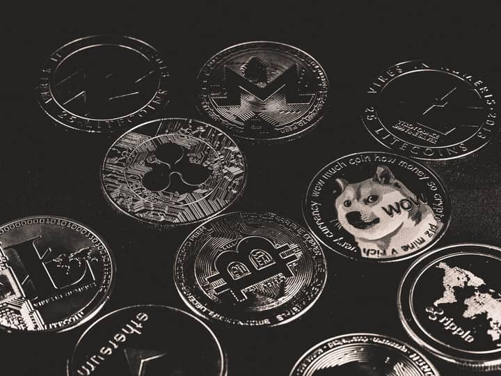 A collection of various cryptocurrency coins including Bitcoin, Ethereum, and Dogecoin.