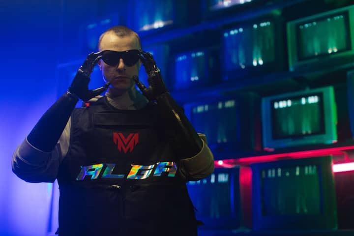 Man in cybernetic outfit adjusts sunglasses, neon-lit room with retro aesthetic.