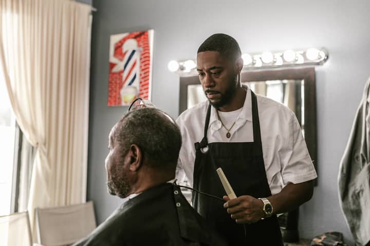 Barber in a modern salon skillfully styling a client's hair, capturing the essence of grooming.