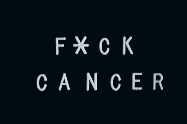 Motivational anti-cancer message on a letter board, emphasizing awareness.