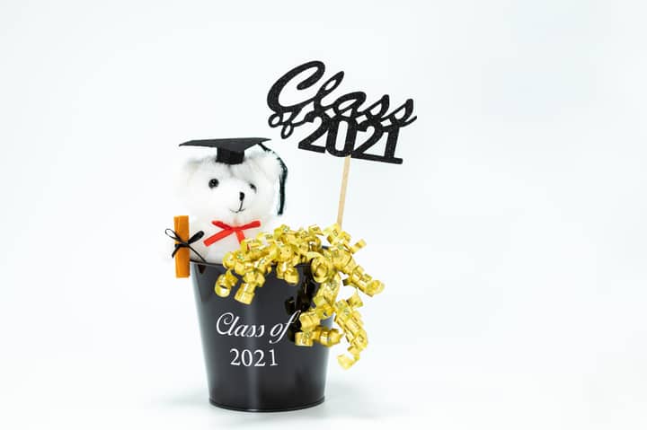 Charming graduation-themed teddy bear gift with cap and diploma in a festive bucket for Class of 2021.